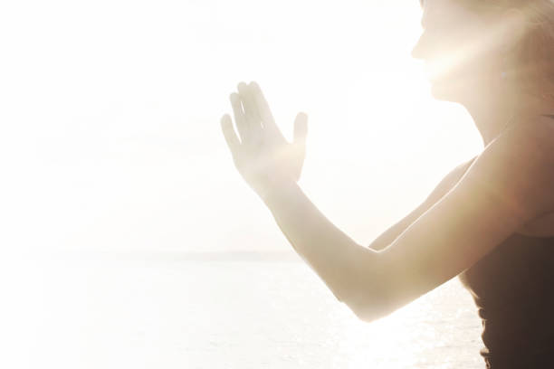 istock praying hands illuminated by the morning sun 978552642