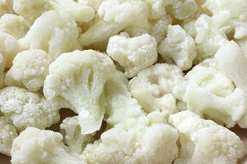 frozen cauliflower, parts of inflorescence are covered with ice, macro