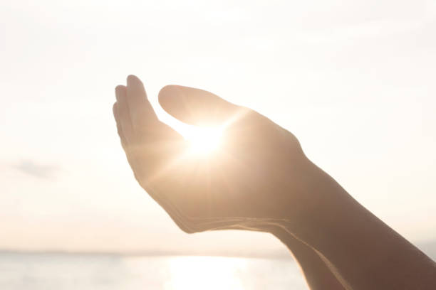 istock woman's hands hold the sun and its energy 978555850