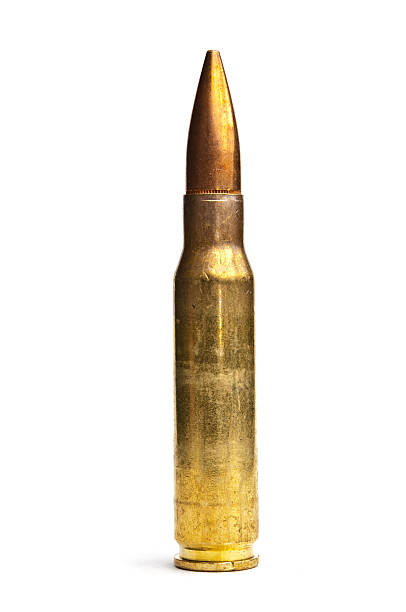 istock Gold rifle bullet standing upright with a white background 97855616