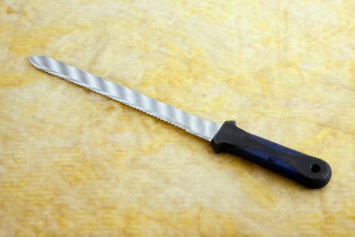 Set of Kitchen knives a cutting board, isolated on a grey background.