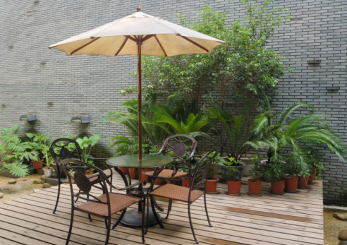 House patio with  table and chairs under umbrella