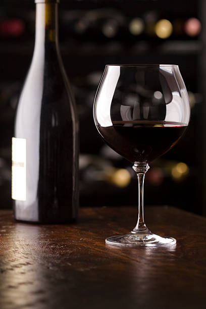 istock wine glass on bar in front of bottle 97856385