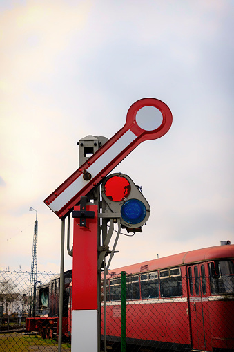 Old railway signal in red and white.