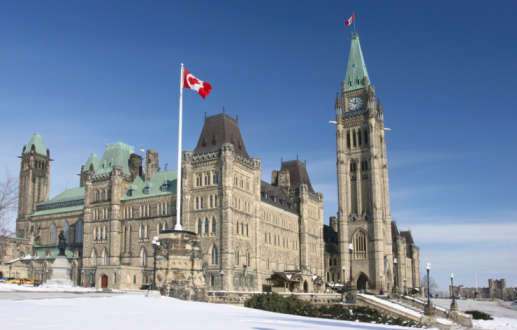 Ottawa, Canada - March 4, 2023 : Parliament Hill West Block building with snow and ice covering the Winter landscape