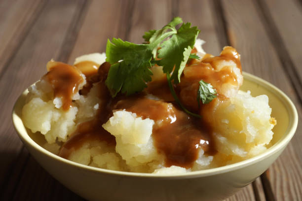 istock Bowl of Mashed Potatoes and Gravy against Rustic Wood Background 978575590