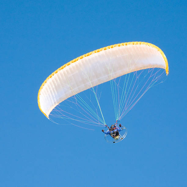 istock Yellow paraglider in serene cloudless blue sky 97857647