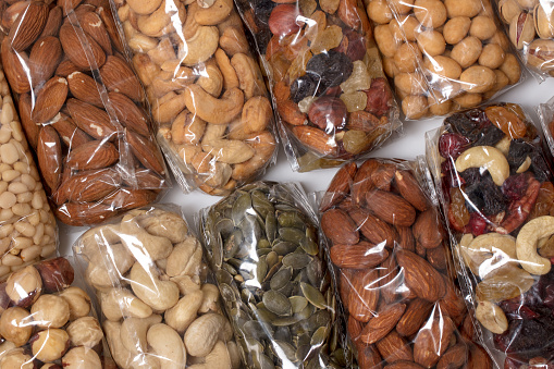 Set of different nuts in transparent plastic packages.