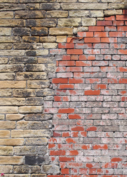 istock old mixed brown stone and and brick patched and repaired wall 978586684
