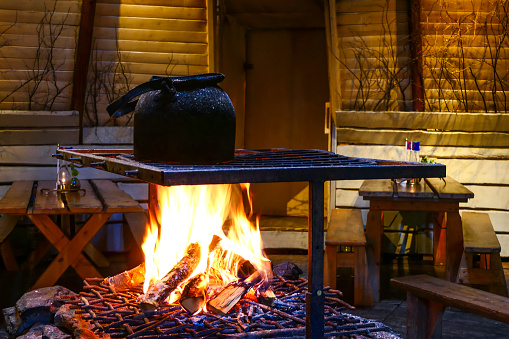 Kiruna, Sweden June 14, 2018 A pot of water boils over an open fire in a Sami camp in Jukkasjarvi.
