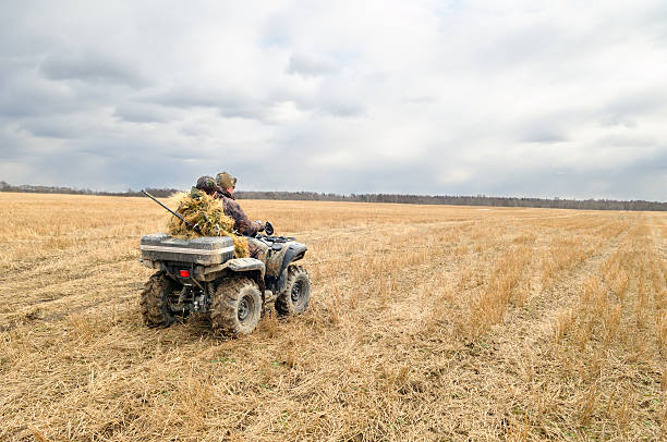 Hunters on quad bikes.  quadbike photos stock pictures, royalty-free photos & images