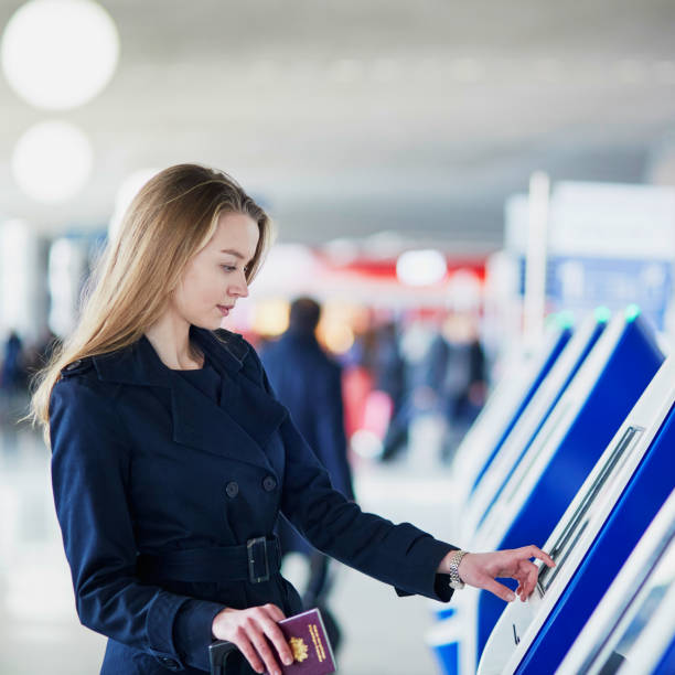 istock Woman in international airport doing self check-in 978606906