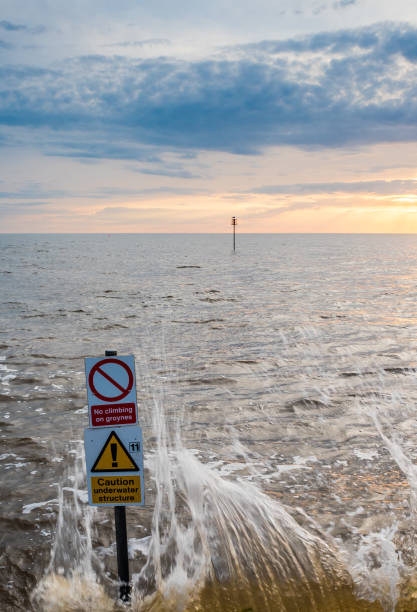 istock sunset over sea in Hunstanton Norfolk with danger signs visible 978612366