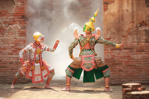 Hanuman (monkey god) fighting Thotsakan (giant) in Khon or Traditional Thai Pantomime as a cultural dancing arts performance in mask dressed based on the character in Ramakien or Ramayana Literature.