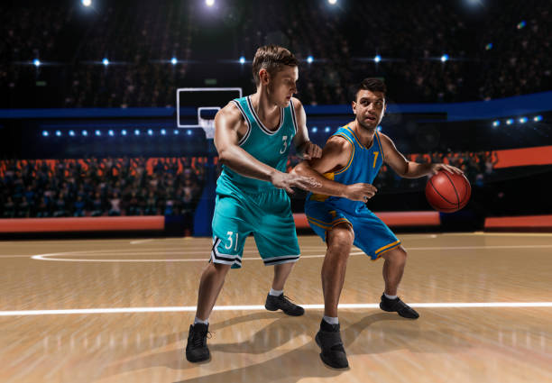 two basketball players during scrimmage on basketball arena