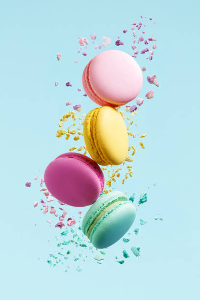 Macaron Dessert. Colorful Macaroons Flying Macaron Dessert. Colorful Macaroons Flying. French Dessert In Motion Falling On Blue Background. High Resolution crumb photos stock pictures, royalty-free photos & images