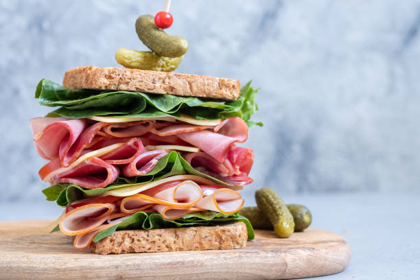 istock Big sandwich with ham, deli meat and vegetables 978624682