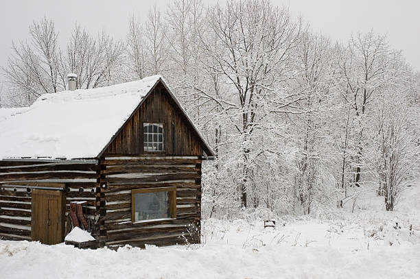 Canadian Log building in snow covered scene stock photo