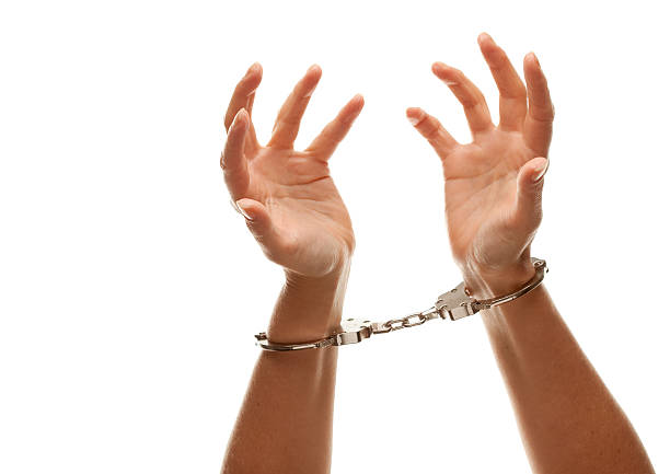 istock Handcuffed Woman Raising Hands in Air on White 97863737