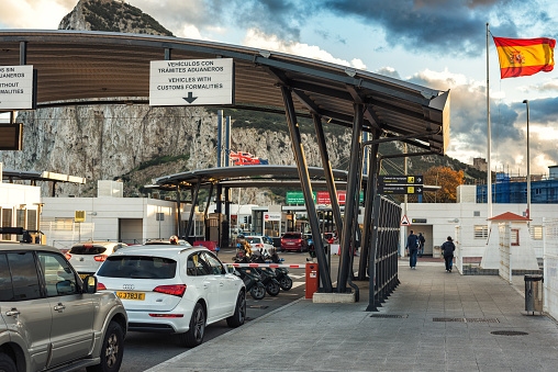 Gibraltar, Europe - December 2017: Customs control point at Spanish border in LaLinea town. Rock of Gibraltar at background - British oversee territory