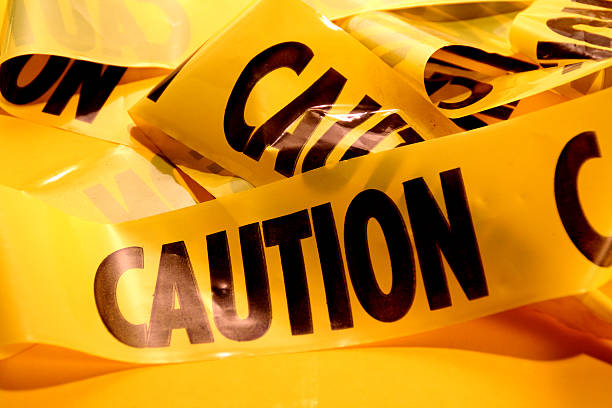Closeup of a pile of caution tape stock photo