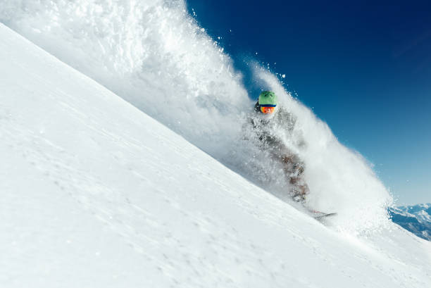 istock man snowboarder is going very fast in   stream of snow avalanche 978641318