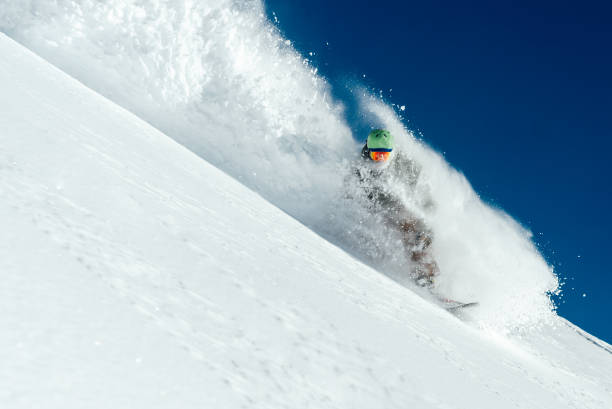 istock man snowboarder is going very fast freeride in stream of snow avalanche 978642206