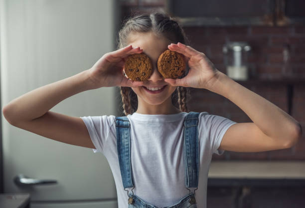 dziewczyna i ciasteczka - domestic kitchen people fun lifestyles zdjęcia i obrazy z banku zdjęć