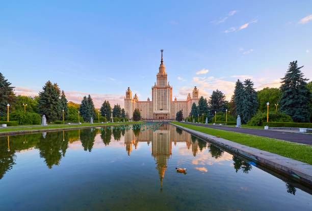 istock Wide angle vibrant panoramic view of sunset Moscow university campus under dramatic sky in spring with water reflections and red ducks 978657864