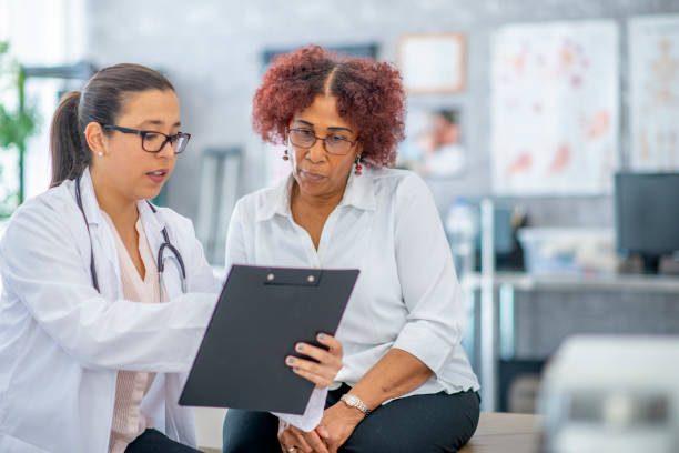 istock Reviewing options with a doctor 978664378