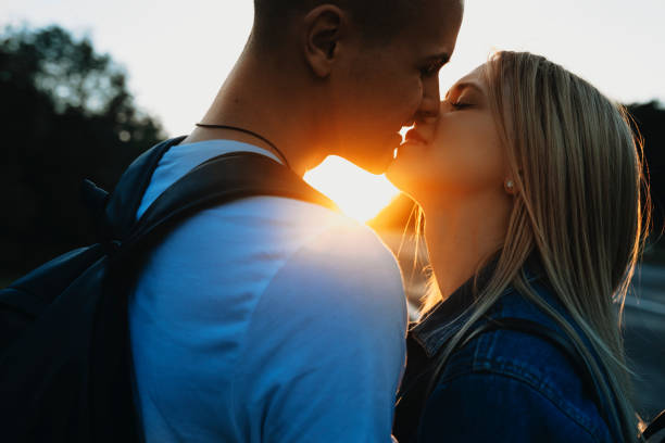 istock Happy couple kissing at sunset 978675032