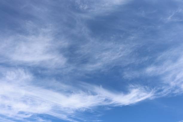 istock Close up of wispy white clouds against blue sky 978681116