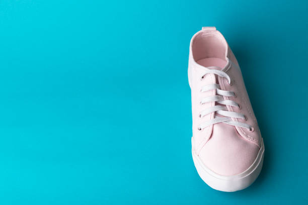 istock pink sneakers on a blue background 978702640