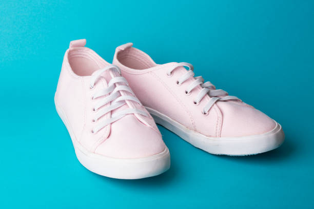 istock pink sneakers on a blue background 978702648
