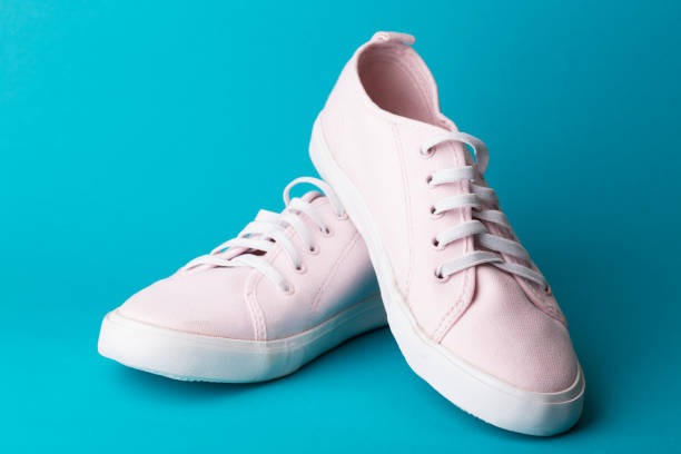 istock pink sneakers on a blue background 978702672