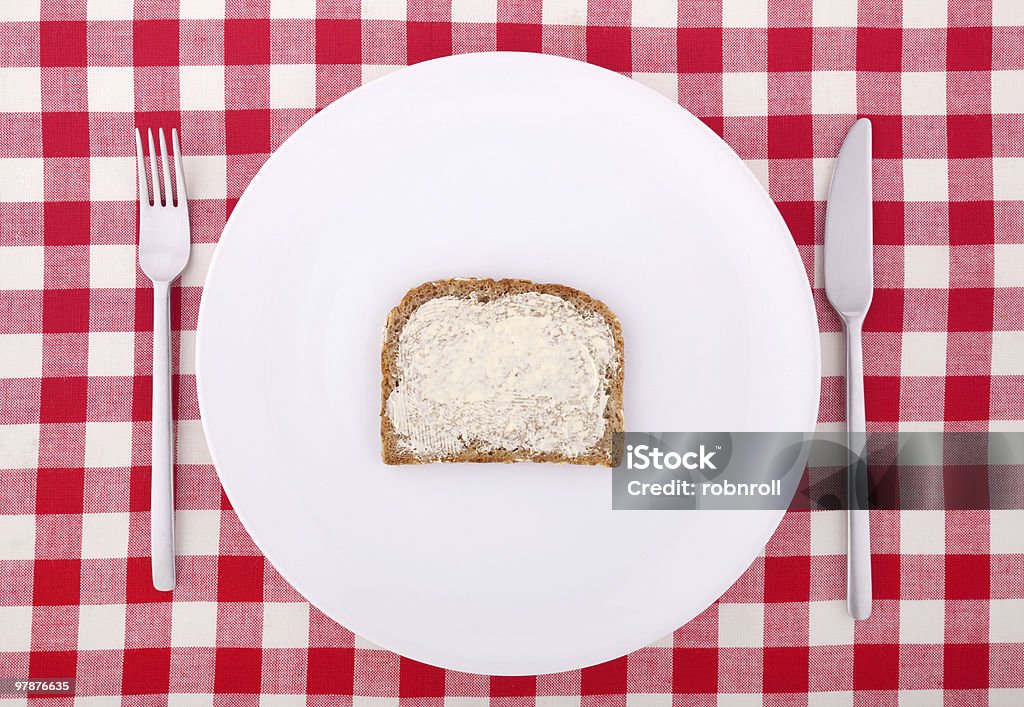 Tischtuch mit Gabel, Messer und eine Scheibe Brot mit Butter - Lizenzfrei Abnehmen Stock-Foto
