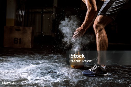 istock Young Man Putting On Sports Chalk For Lifting Barbell 978776494