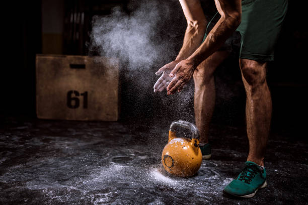 istock Young Man Putting On Sports Chalk For Lifting Barbell 978778382