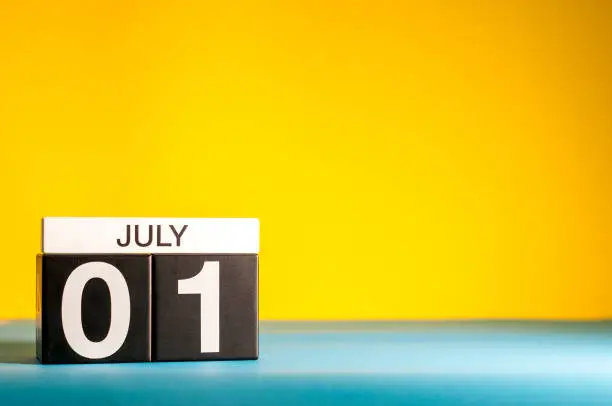 Photo of July 1st. Image of july 1, calendar on yellow background with empty space for text. Summer time