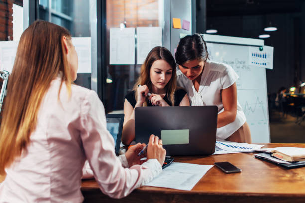 istock Business team working together studying charts and diagrams using laptop in modern office 978789978