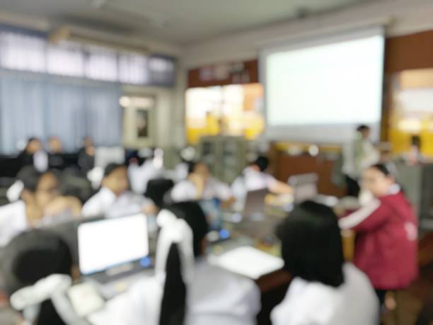 istock Blurred image of group of students are learning and lecture and using computer together in classroom for study and workshop in computers room at school. education technology or training concept. 978794356