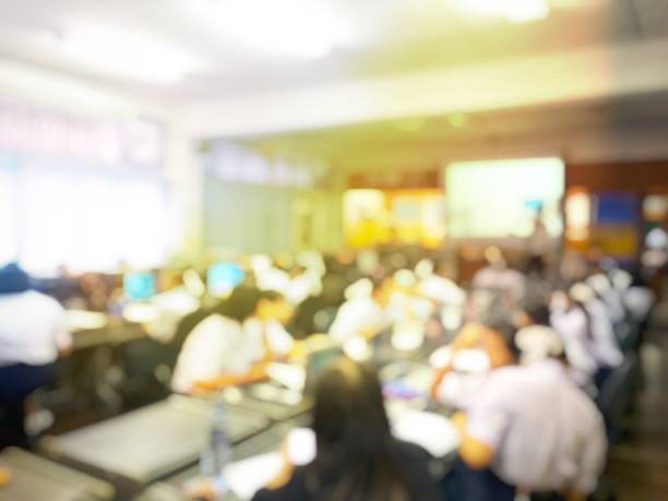 istock Blurred image of group of students are learning and lecture and using computer together in classroom for study and workshop in computers room at school. education technology or training concept. 978794528