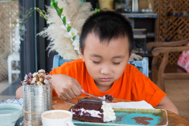 istock Boy eating chocolate cakes 978823594
