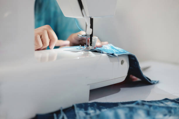 istock ailoring Process - Women's hands behind her sewing 978832730