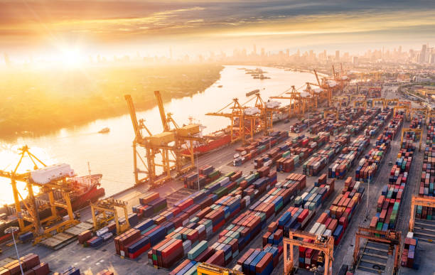 istock Logistics and transportation of Container Cargo ship and Cargo plane with working crane bridge in shipyard at sunrise, logistic import export and transport industry background 978841896
