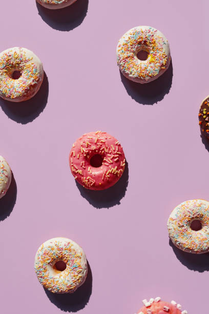 istock Colorful Donuts On Purple Background In Summer 978900316