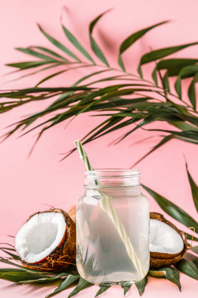 istock Coconut water and coconuts on a bright pastel background, selective focus 978909568