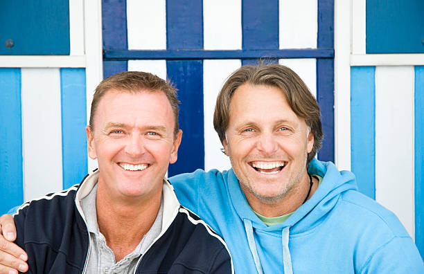 Two gay men laughing together. stock photo