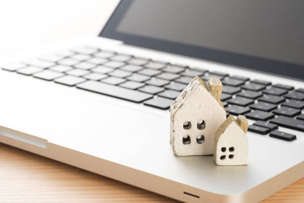 istock Laptop with Miniature House 978930738