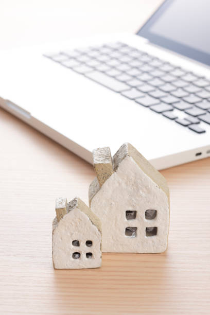 istock Laptop with Miniature House 978930750